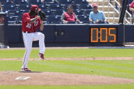 FILE - Washington Nationals starting pitcher Trevor Williams (32) winds up to throw as the pitch clock runs during the fourth inning of a spring training baseball game against the Miami Marlins, Saturday, March 18, 2023, in West Palm Beach, Fla. (AP Photo/Lynne Sladky, File)