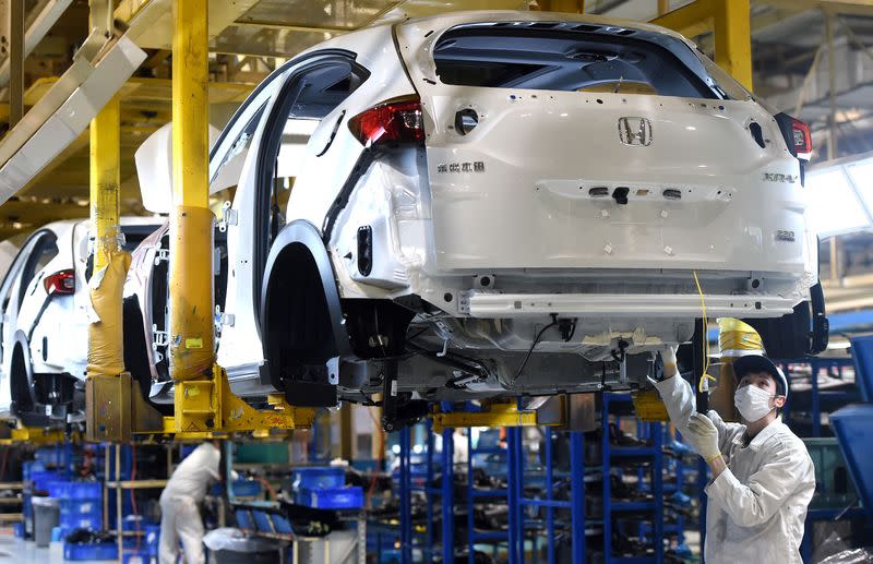 Worker wearing a face mask is seen on a production line at the plant of Dongfeng Honda Automobile Co in Wuhan