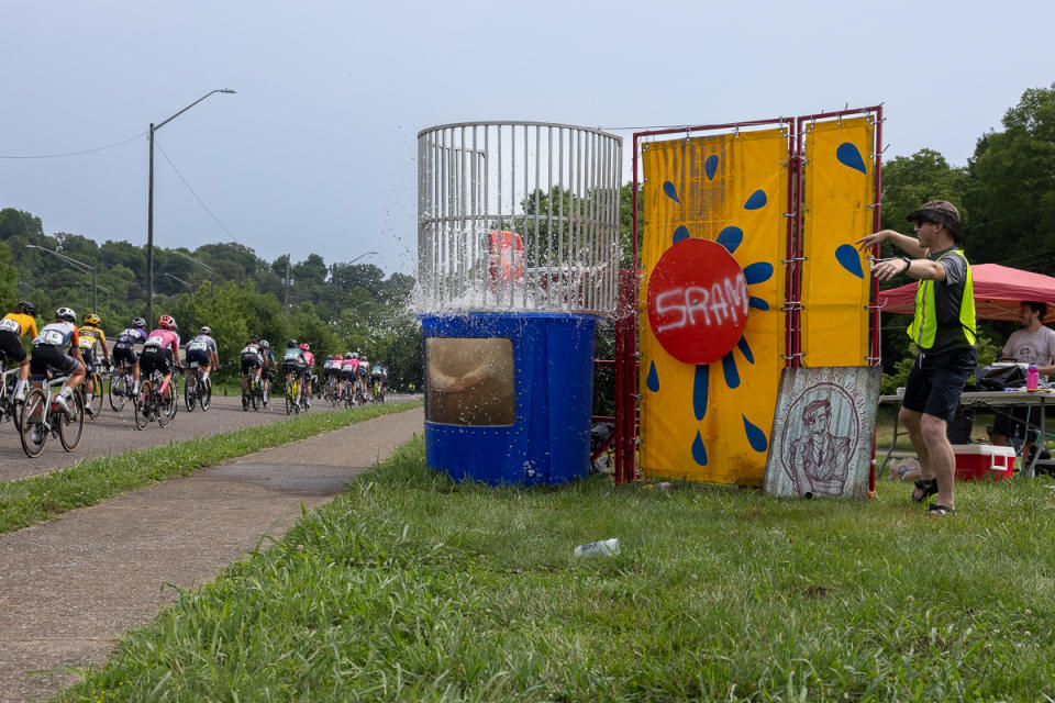 Fans put a dunk tank in the green zone for riders to tose unwanted bottle at.