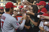 Los Angeles Angels' Shohei Ohtani signs autographs before a baseball game against the Cleveland Guardians, Monday, Sept. 12, 2022, in Cleveland. (AP Photo/David Dermer)