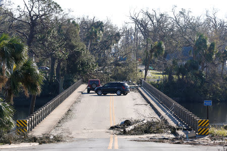 Drivers turn around on a bridge blocked by debris in the aftermath of Hurricane Michael in Panama City, Florida, U.S., October 13, 2018. REUTERS/Terray Sylvester