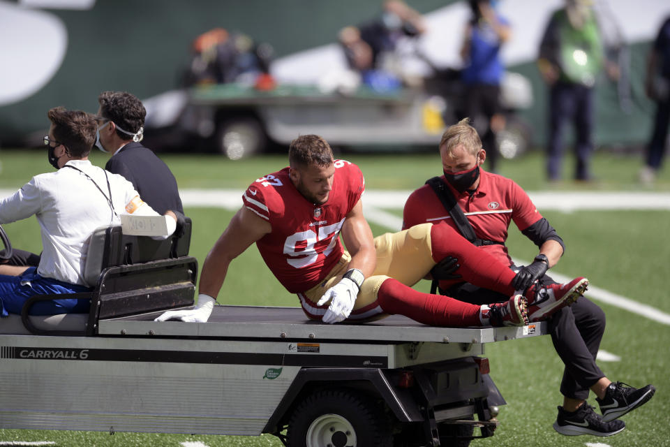 San Francisco 49ers defensive end Nick Bosa (97) is driven off the field after being injured during the first half of an NFL football game against the New York Jets Sunday, Sept. 20, 2020, in East Rutherford, N.J. After losing four players to knee injuries last week against the New York Jets, the Niners complained about a “sticky” new turf at MetLife Stadium and expressed some concern about returning to the same field a week later. (AP Photo/Bill Kostroun, File)