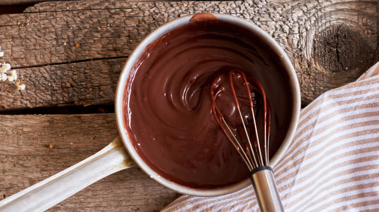 Whisking chocolate gravy in saucepan