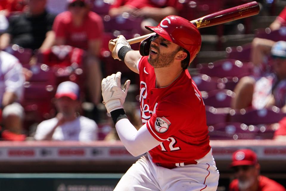 Cincinnati Reds right fielder Tyler Naquin (12) hits a single in the eighth inning during a baseball game against the San Francisco Giants, Sunday, May 29, 2022, at Great American Ball Park in Cincinnati. The San Francisco Giants won, 6-4.