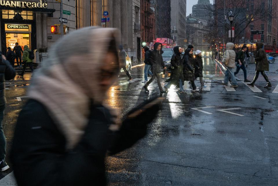 People walk through New York City amid wintry precipitation on 6 January (Getty Images)