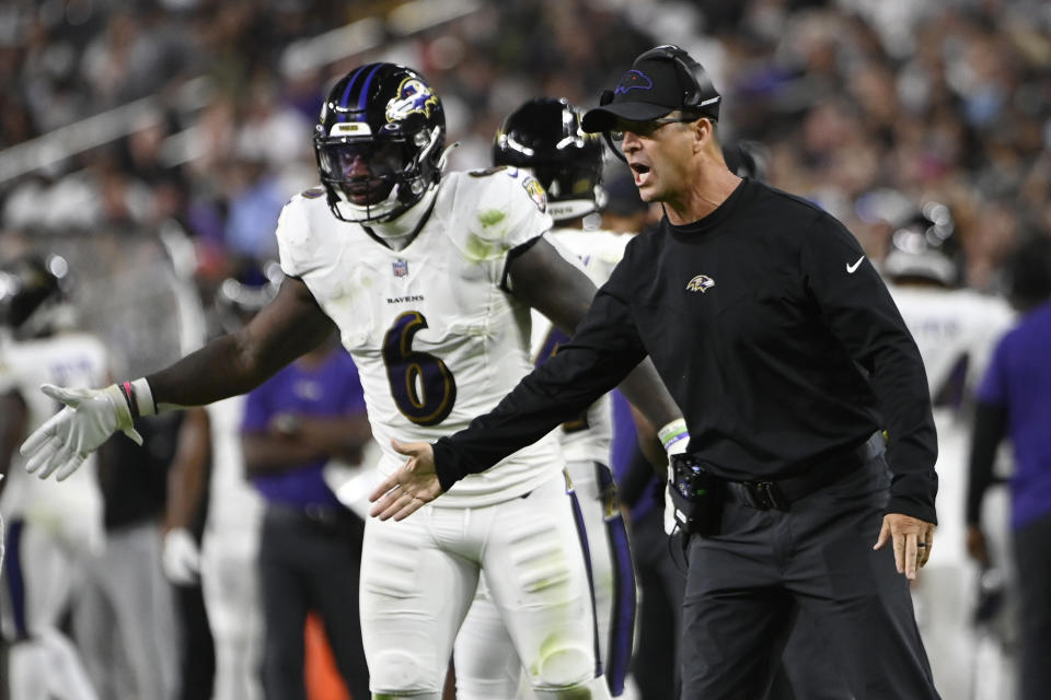 Baltimore Ravens head coach John Harbaugh motions to his players during the second half of an NFL football game against the Las Vegas Raiders, Monday, Sept. 13, 2021, in Las Vegas. (AP Photo/David Becker)