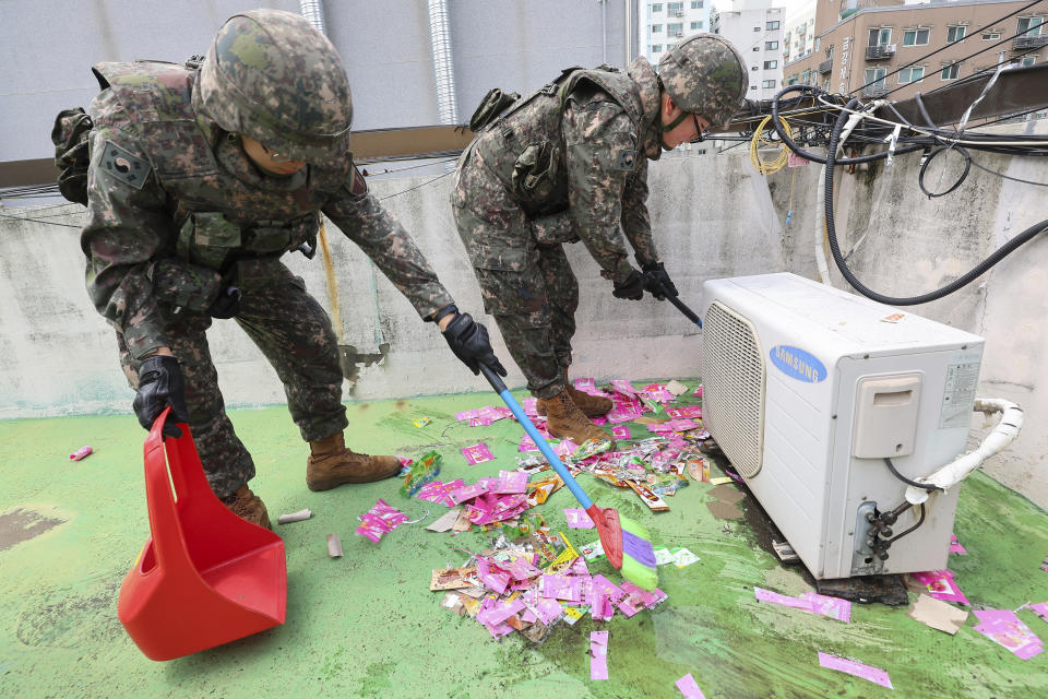 South Korean army soldiers collect the trash from a balloon presumably sent by North Korea, in Incheon, South Korea, Wednesday, July 24, 2024. (Lim Sun-suk//Yonhap via AP)