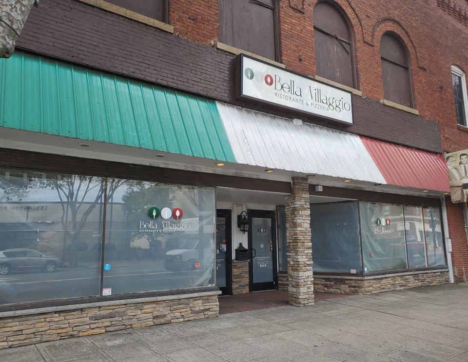 Gray paper covers the windows of the former Bella Villaggio in downtown Lexington, which has been purchased by a Greensboro couple. They are working with family and friends to gut the place for a new restaurant and family pool hall, as well as two apartments above the restaurant.