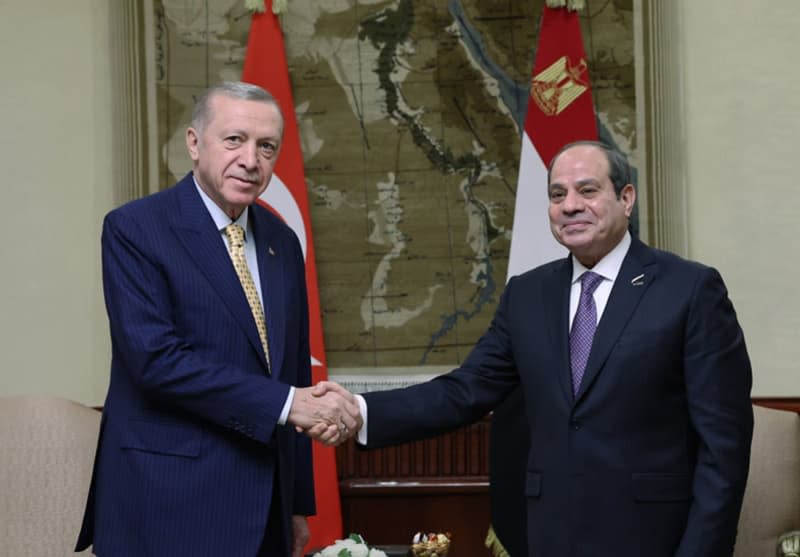 Presdient of Turkey Recep Tayyip Erdogan and President of Egypt Abdel Fattah al-Sisi, shake hands ahead of their meeting. Erdogan arrived in Cairo on 14 February for talks with al-Sisi in a landmark visit that comes after around a decade of diplomatic strain between the two countries. -/Presidency of the Republic of Turkey/dpa