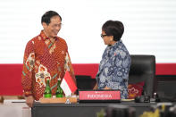 Vietnam's Foreign Minister Bui Thanh Son, left, talks to Indonesian Foreign Minister Retno Marsudi, right, during the Association of Southeast Asian Nations (ASEAN) foreign ministers retreat in Jakarta, Indonesia, Saturday, Feb. 4, 2023. (AP Photo/Achmad Ibrahim)