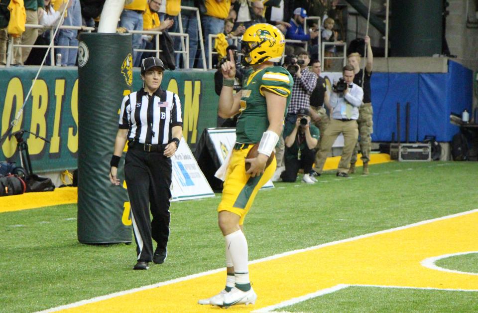 Cam Miller holds up one finger toward Bison fans after his touchdown run gave the Bison a 14-7 lead on South Dakota State in the first quarter of Saturday's game at the Fargodome.