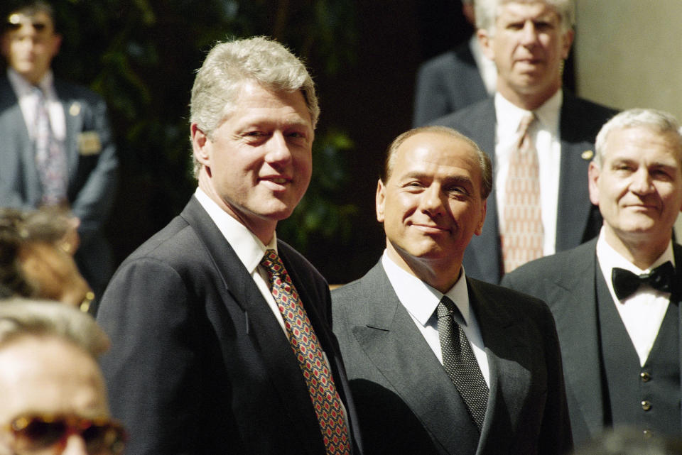 FILE - In this , June 2, 1994 file photo, President Bill Clinton and Italian Premier Silvio Berlusconi, right, pose for photographers prior to their meeting at Villa Madama in Rome. Berlusconi, the boastful billionaire media mogul who was Italy's longest-serving premier despite scandals over his sex-fueled parties and allegations of corruption, died, according to Italian media. He was 86. (AP Photo/Silvano Festuccia, File)