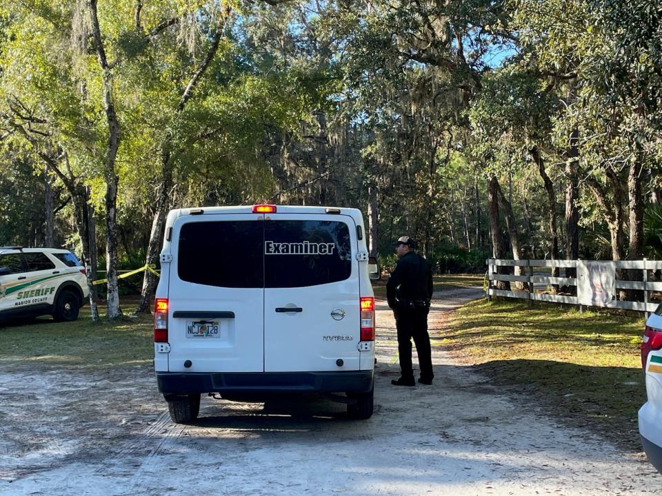 A sheriff's deputy talks with an official from the Medical Examiner's Office who went to the scene of a deputy-involved shooting Monday night.