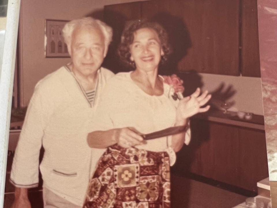 Morrie and Betty Markoff are pictured getting ready to eat a cake. A note reads 1976