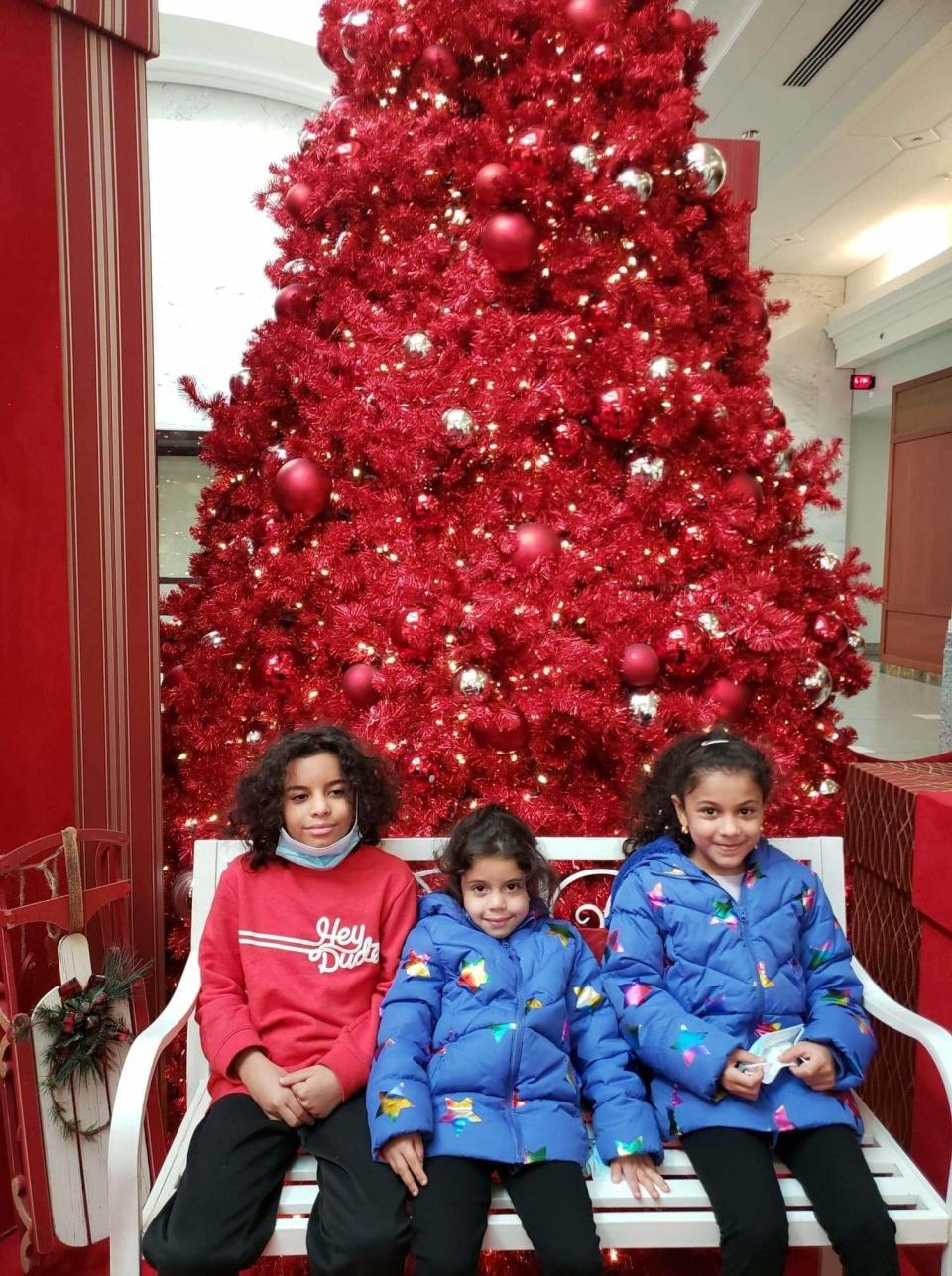 Mohammed, Judy, and Rodina Abdelrhman of Mount Holly visit a Christmas display at Moorestown Mall. Last year they received new clothes to replace hand-me-downs thanks to the Give A Christmas program sponsored by the Burlington County Times and the New Jersey 211 help line for social services