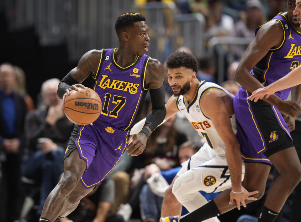 Los Angeles Lakers guard Dennis Schroder, left, drives to the basket past Denver Nuggets guard Jamal Murray in the first half of an NBA basketball game Monday, Jan. 9, 2023, in Denver. (AP Photo/David Zalubowski)