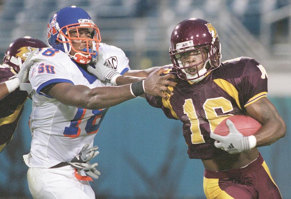 Bethune-Cookman's Rashean Mathis (16) pushes off from Morgan State's Thomas Potts (18) on a punt return early in the second quarter of a college football game on September 1, 2001. [Bob Self/Florida Times-Union]