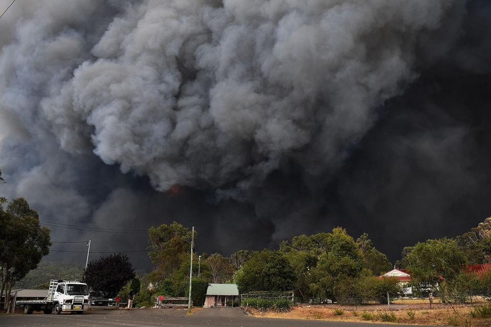 Smoke from a bushfire approaches the Old Hume Highway near the town of Tahmoor, New South Wales, Australia, on Dec. 19, 2019.