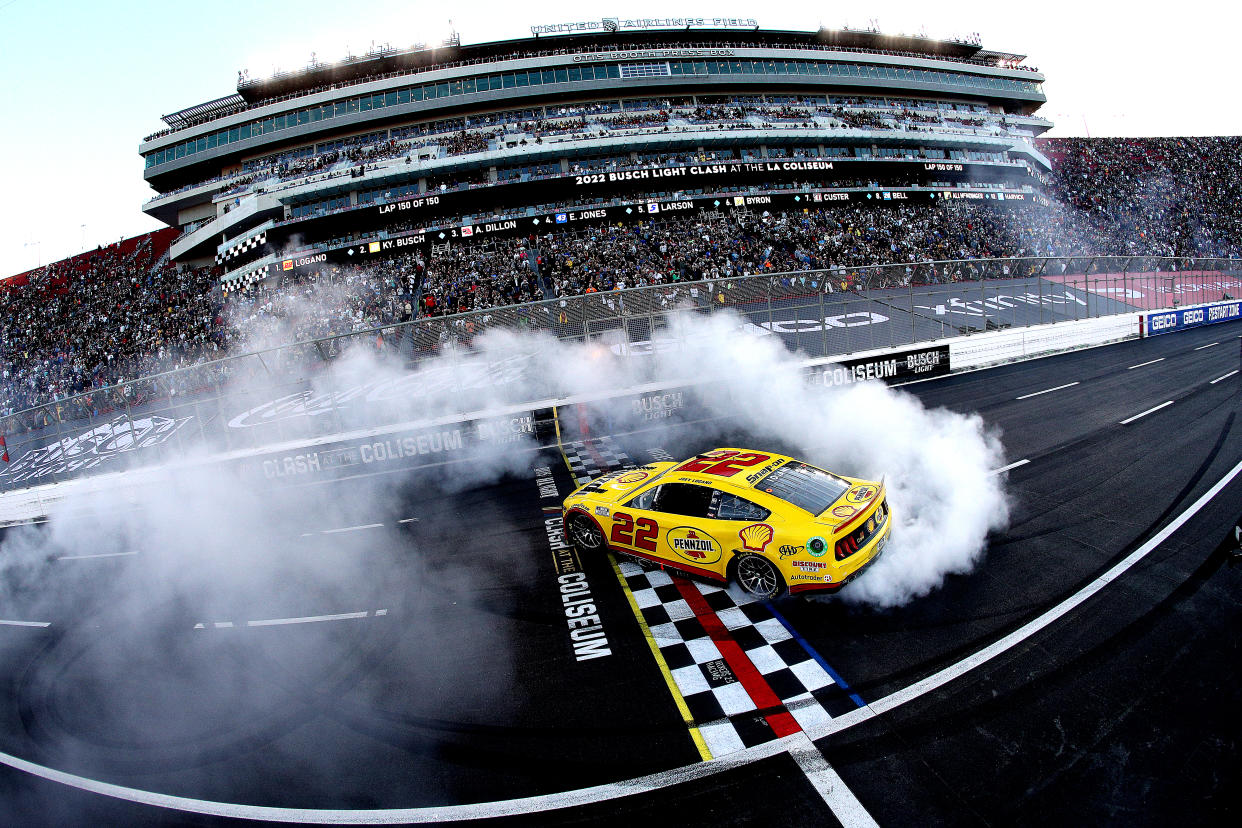LOS ANGELES, CALIFORNIA - FEBRUARY 06: Joey Logano, driver of the #22 Shell Pennzoil Ford, celebrates with a burnout after winning the NASCAR Cup Series Busch Light Clash at the Los Angeles Memorial Coliseum on February 06, 2022 in Los Angeles, California. (Photo by Sean Gardner/Getty Images)