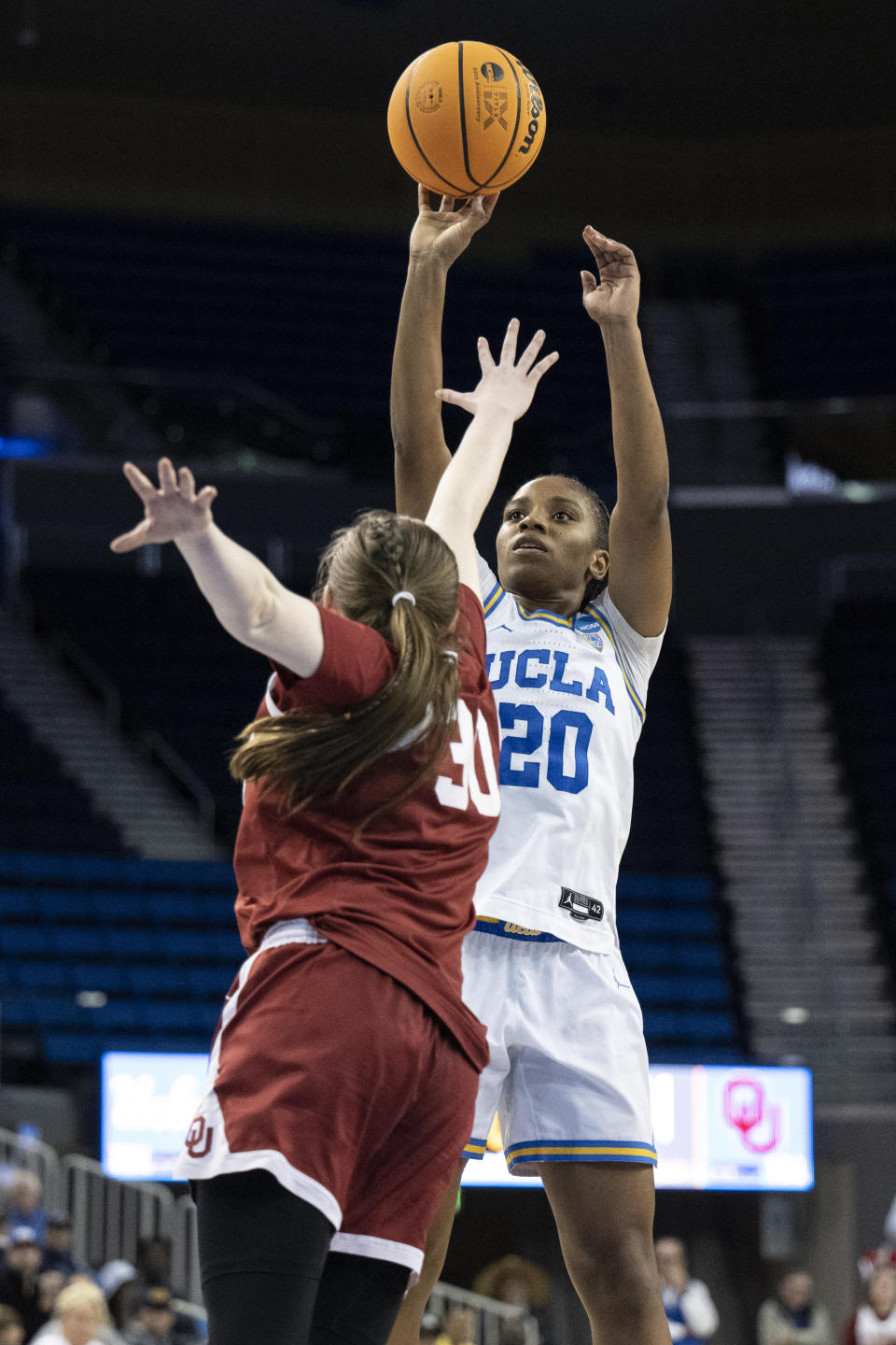 UCLA guard Charisma Osborne (20) shoots over Oklahoma guard Taylor Robertson (30) during the second half of a second-round college basketball game in the NCAA Tournament, Monday, March 20, 2023, in Los Angeles. (AP Photo/Kyusung Gong)