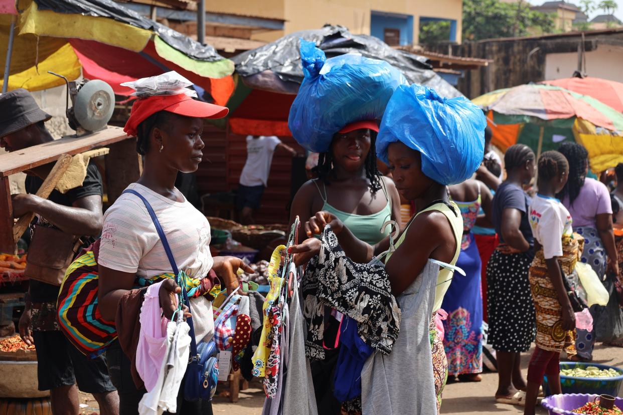 A vendor sells daily necessities at a market in Freetown, Sierra Leone, Feb. 21, 2024.