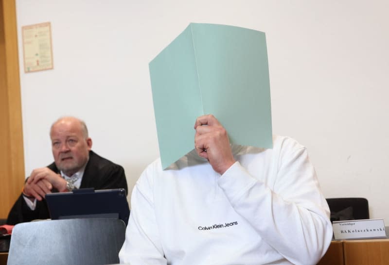 The main defendant (R) sits in the dock in a courtroom as he admitted to setting off a firecracker that was not licensed in Germany in the visitors' block on 11 November 2023 during the Bundesliga match between FC Augsburg and TSG 1899 Hoffenheim. Karl-Josef Hildenbrand/dpa