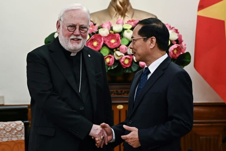 Vietnam's Foreign Minister Bui Thanh Son shakes hands with the Vatican's de facto foreign minister Archbishop Paul Gallagher (Nhac NGUYEN)