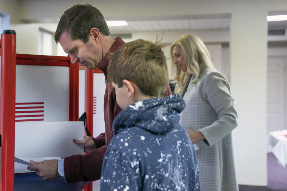 Kentucky Attorney General and democratic Gubernatorial candidate Andy Beshear studies his ballot at the Knights of Columbus polling location Tuesday, Nov. 5, 2019, in Louisville, Ky. Kentucky's voters are now deciding the political grudge match between Republican Gov. Matt Bevin and Beshear. (AP Photo/Bryan Woolston)