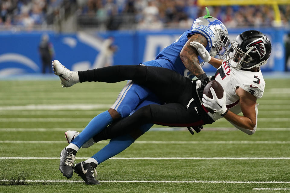 Atlanta Falcons wide receiver Drake London (5) is brought down by Detroit Lions safety Brian Branch in the second half of an NFL football game, Sunday, Sept. 24, 2023, in Detroit. (AP Photo/Paul Sancya)