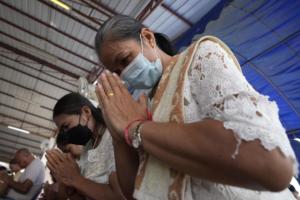 Relatives of the victims pray during the Buddhist ceremony in the rural town of Uthai Sawan, in Nong Bua Lamphu province, northeastern Thailand, Friday, Oct. 6, 2023. A memorial service takes place to remember those who were killed in a grisly gun and knife attack at a childcare center. A former police officer killed 36 children and teachers in the deadliest rampage in Thailand's history one year ago. (AP Photo/Sakchai Lalit)