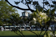 Dogwood flowers frame the clubhouse during a practice round for the Masters golf tournament on Monday, April 5, 2021, in Augusta, Ga. (AP Photo/David J. Phillip)