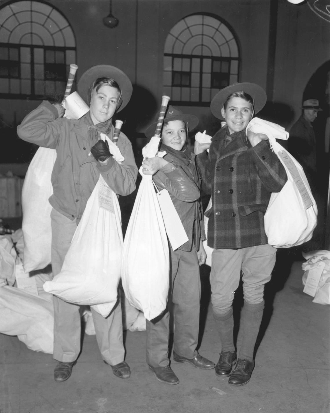 Dec. 23, 1944: Boy Scouts Harold Wayland, left, Clifford Yeldell and Guy Guyette of Troop 22 shoulder Goodfellow bundles of Christmas presents before loading them on a waiting truck. Fort Worth Star-Telegram archive/UT Arlington Special Collections