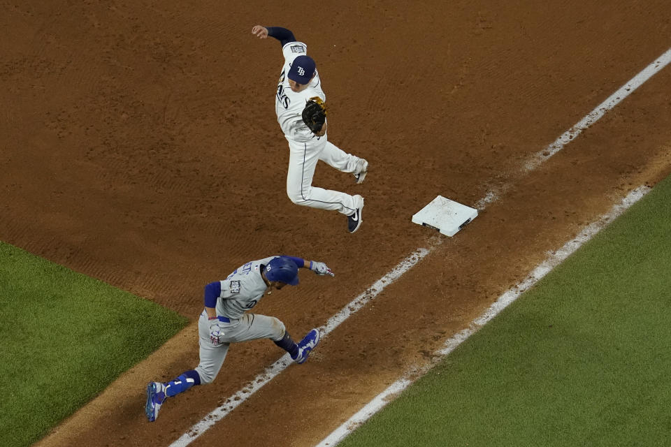 Tampa Bay Rays first baseman Ji-Man Choi tags out Los Angeles Dodgers' Mookie Betts at first base during the eighth inning in Game 3 of the baseball World Series Friday, Oct. 23, 2020, in Arlington, Texas. (AP Photo/David J. Phillip)