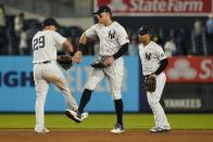 New York Yankees' Gleyber Torres, right, Aaron Judge, center, and Gio Urshela celebrate after a baseball game against the Texas Rangers, Monday, Sept. 20, 2021, in New York. (AP Photo/Frank Franklin II)