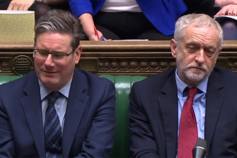 An unimpressed Jeremy Corbyn, Britain's opposition Labour Party leader (r), and his Brexit spokesman Keir Starmer listen on as PM May addresses the House of Commons on Monday