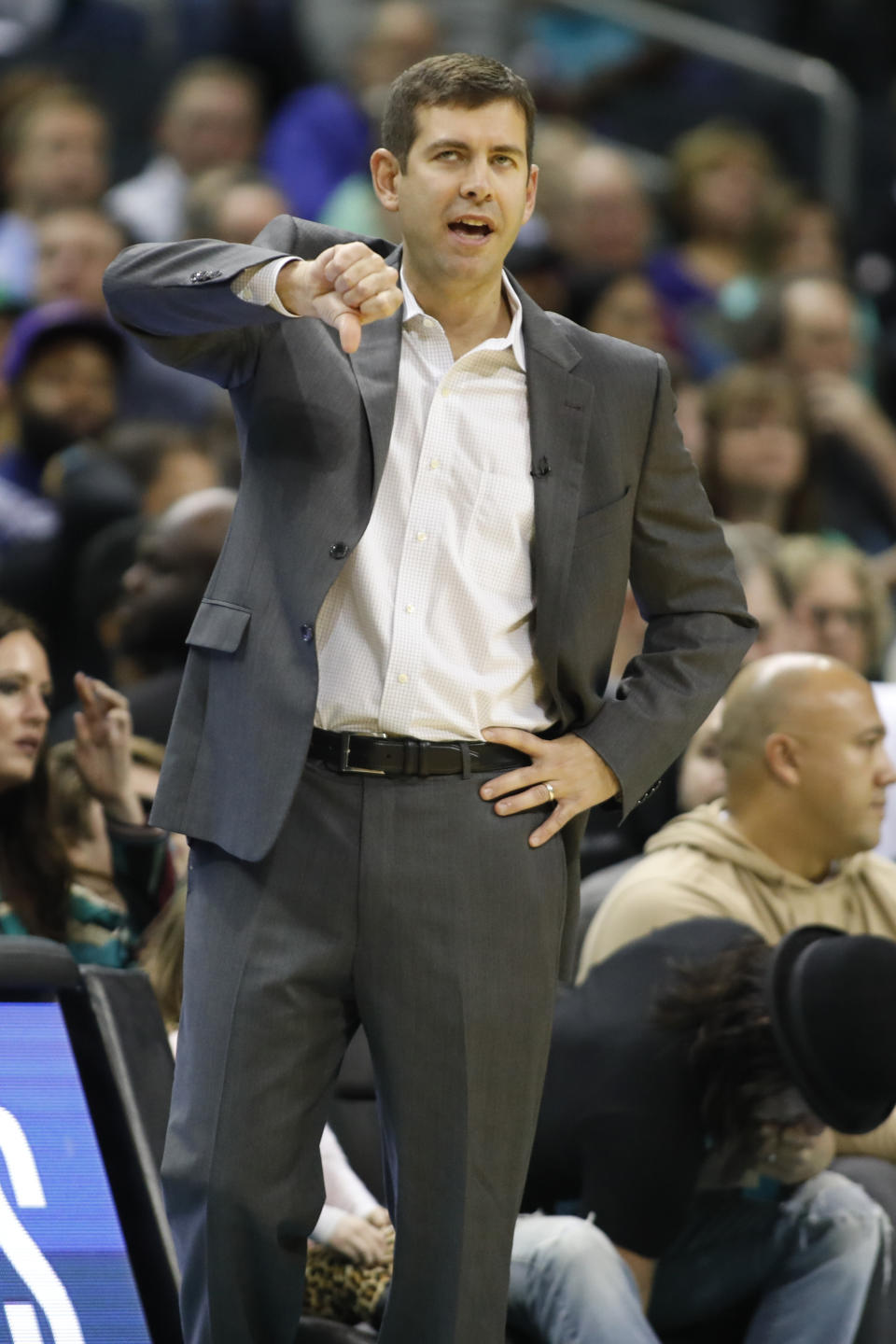 Boston Celtics coach Brad Stevens makes a call from the bench during the first half of the team's NBA basketball game against the Charlotte Hornets in Charlotte, N.C., Thursday, Nov. 7, 2019. (AP Photo/Bob Leverone)