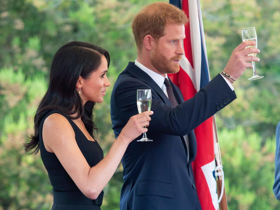 Meghan Markle and Prince Harry make a toast.