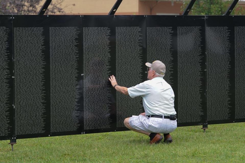 Army veteran James Beaver, of Dover, looks for the names of friends from the Vietnam War on The Wall That Heals, a traveling replica of the Vietnam Veterans Memorial in Washington, D.C., while it was on display at the Kent County Veterans Memorial Park in Dover, Del., in 2015.