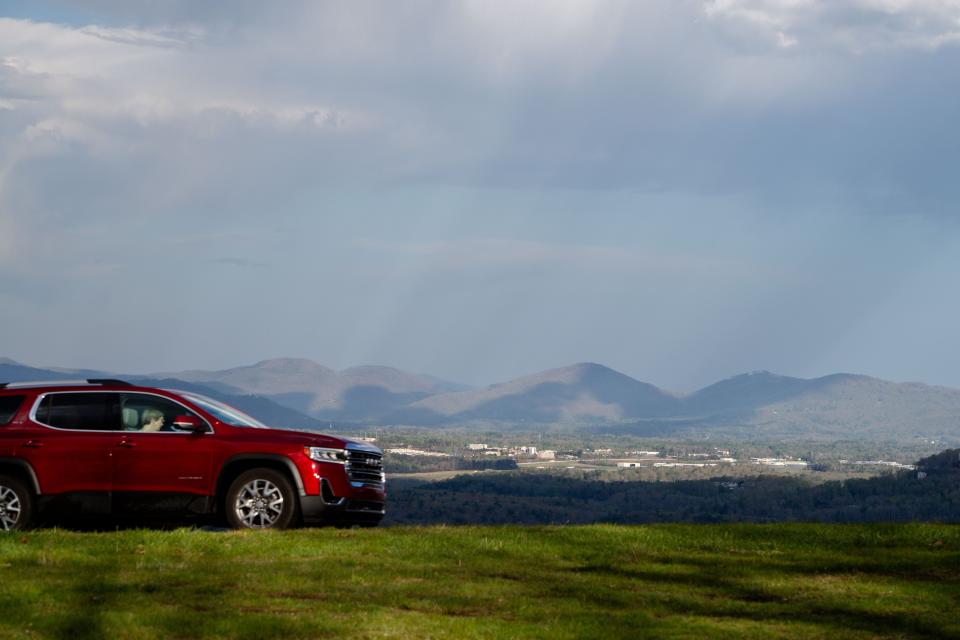 Rain falls in the distance as a motorist travels on the Blue Ridge Parkway, April 15, 2024.