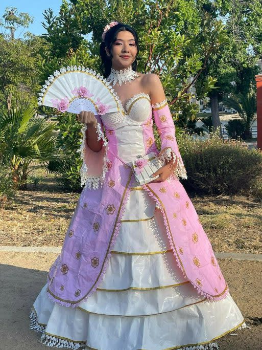 Karla Torres poses in pink and white French art-inspired duct tape gown. (Photo via Stuck At Prom)