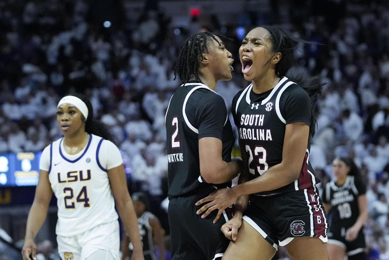 South Carolina guard Bree Hall (23) and forward Ashlyn Watkins (2) celebrate as LSU guard Aneesah Morrow (24) walks down court in the final moments of the second half of an NCAA college basketball game in Baton Rouge, La., Thursday, Jan. 25, 2024. South Carolina won 76-70. (AP Photo/Gerald Herbert)