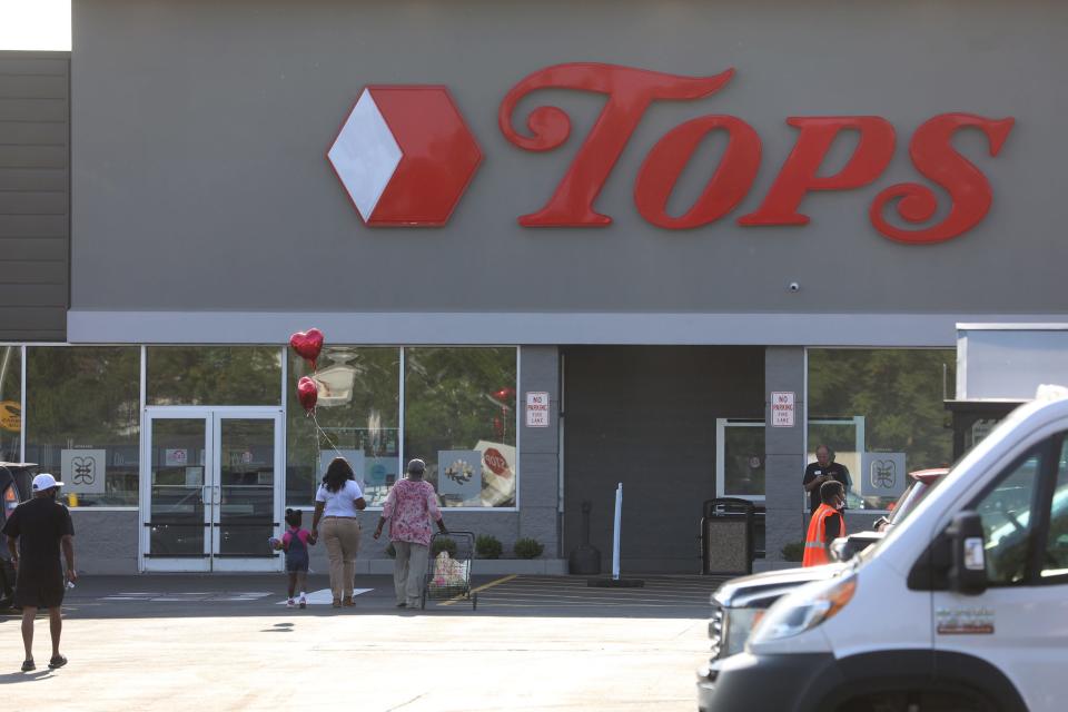 One resident, LeCandice Durham, walks a customer she recognized from the area to the store.  Durham had been  welcoming people as they headed into Tops Friendly Market on Jefferson Ave, in Buffalo, NY on Friday, July 15, 2022.   She believes that the only way for the community to heal  is for everyone to come together.  Other people protested the opening while standing in front of the store on Jefferson Ave.  The store opened two months after 10 people were killed and three injured in a mass shooting that targeted Black people.