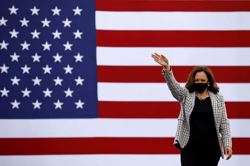 U.S. Democratic vice presidential nominee Senator Kamala Harris waves supporters as she arrives for a campaign drive-in rally in West Palm Beach