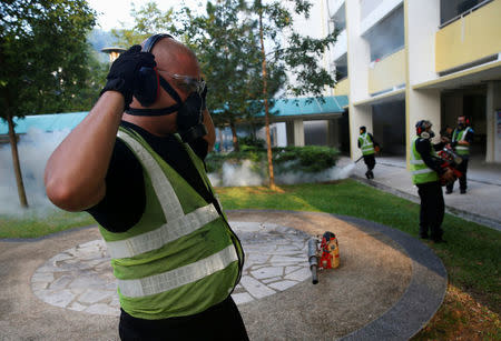 A worker prepares to fog the common areas of a public housing estate at an area where locally transmitted Zika cases were discovered in Singapore August 31, 2016. REUTERS/Edgar Su