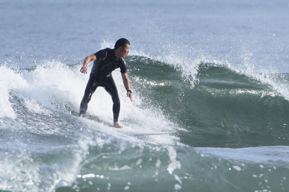 A man surfs at the Yotsukura beach in Iwaki, northeastern Japan, Thursday, July 13, 2023. (AP Photo/Hiro Komae)