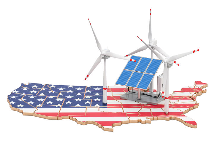 A map of the United States painted in the American flag and toy wind turbines and solar panels sitting on top.