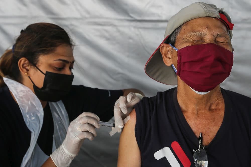 Members of the public receive their Covid-19 shot through the MYMedic@Wilayah Vaccine Mobile Truck programme at PPR Sg. Bonus in Setapak, Kuala Lumpur June 21, 2021. — Picture by Yusof Mat Isa