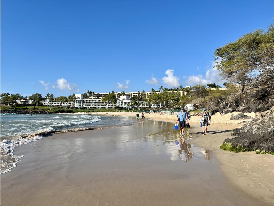 The view of the north side of Hapuna Beach by the resort, with the sand, water, and white building