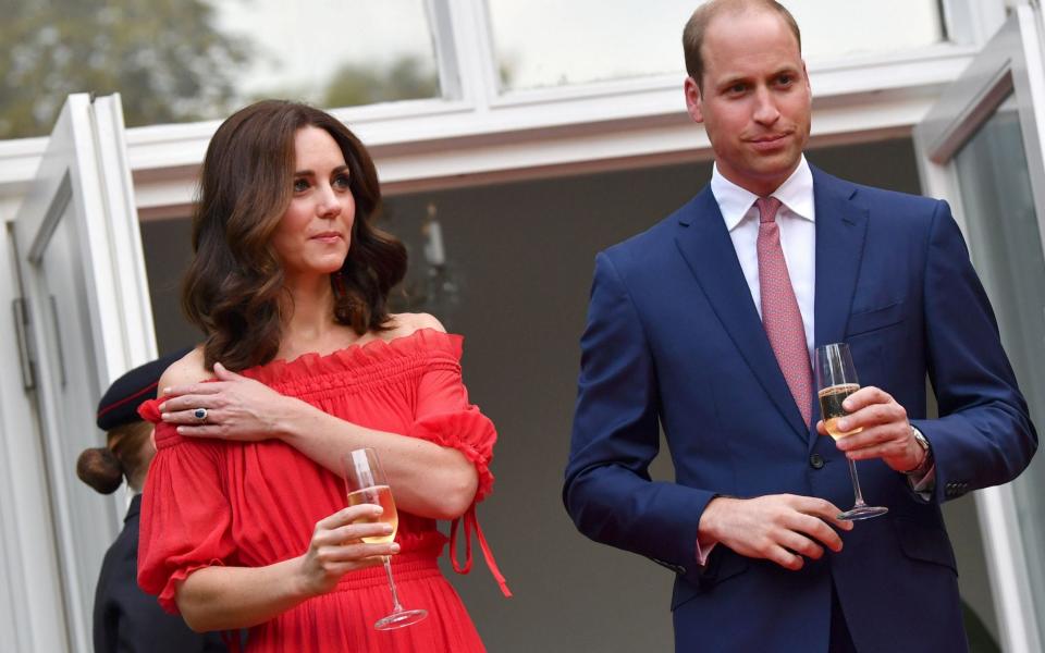 Britain's Prince William, Duke of Cambridge, his wife Kate, the Duchess of Cambridge attend the Queen's Birthday Garden Party at the Ambassador's Residence in Berlin - Credit: JENS KALAENE