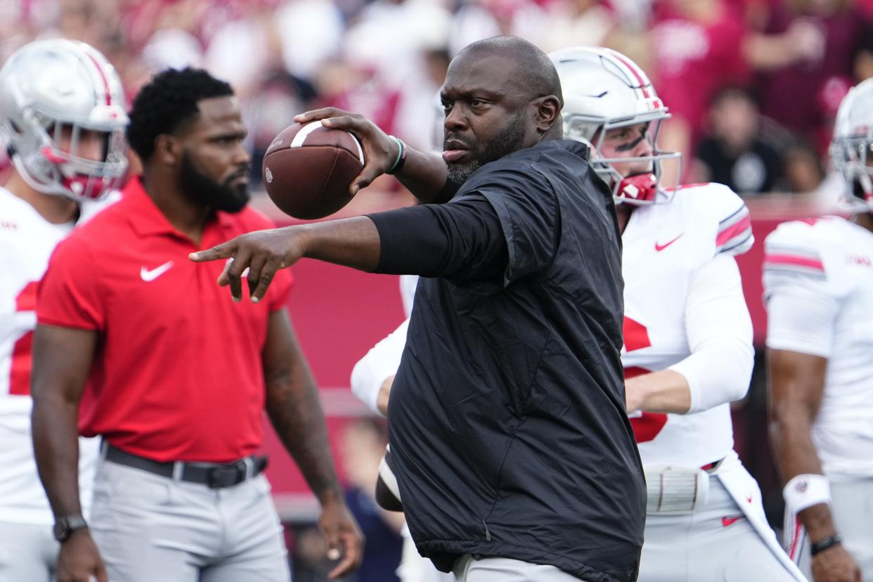 Sep 2, 2023; Bloomington, Indiana, USA; Ohio State Buckeyes running backs coach Tony Alford throws during warm ups prior to the NCAA football game at Indiana University Memorial Stadium. Ohio State won 23-3.